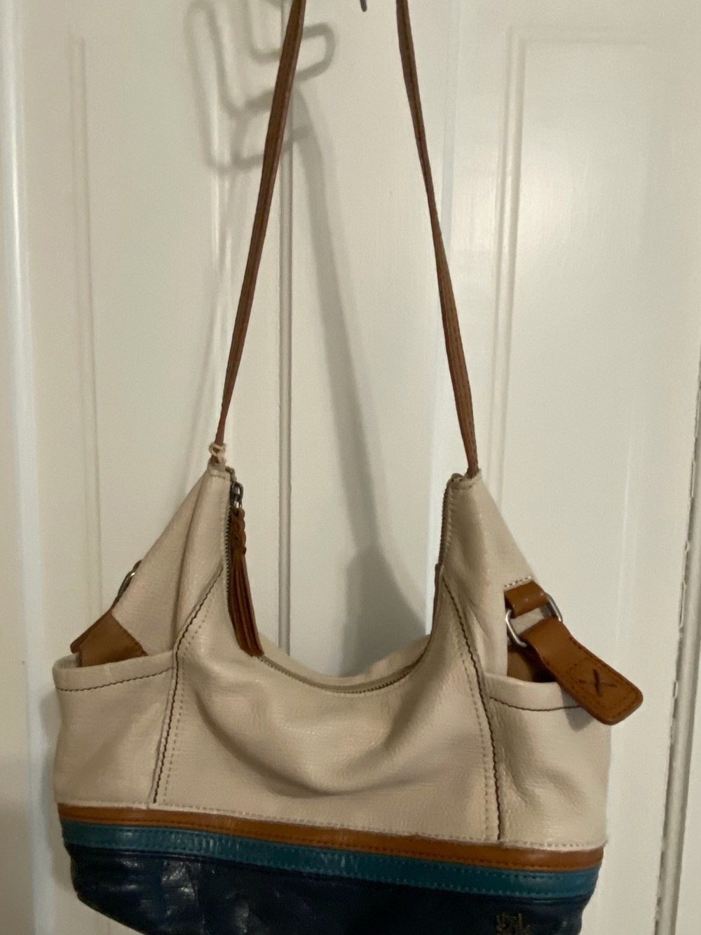 The Sak Cream Shoulder Bag with Tan and Blue Accents